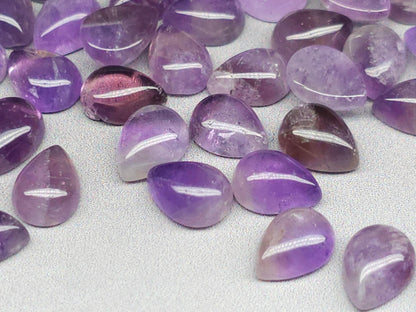 Amethyst pear cabochon side view showing flat back profile