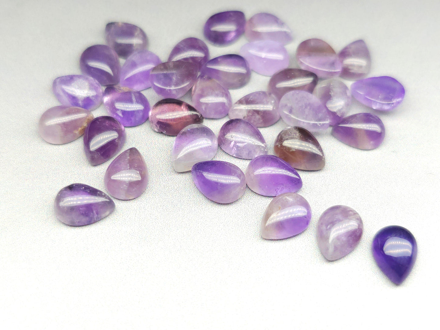 8mm amethyst pear cab showing purple colour and teardrop shape